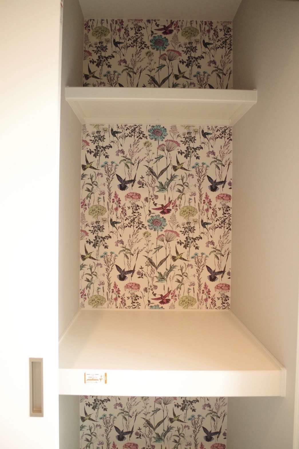 収納クローゼットの奥にもボタニカル柄のクロスを使用。